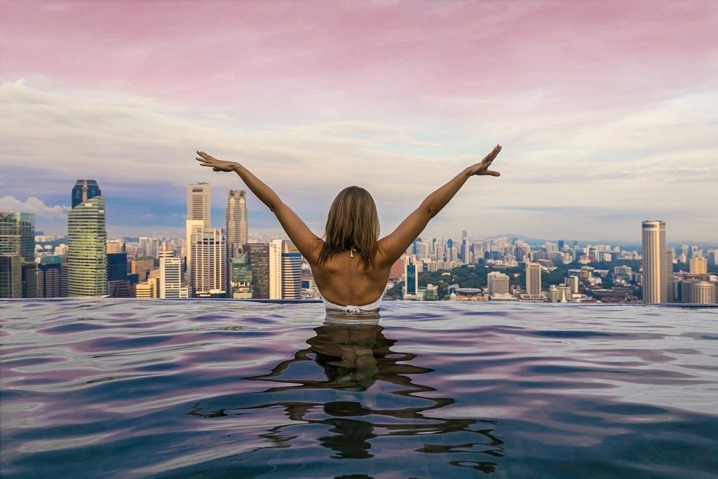 Woman in the pool with city view