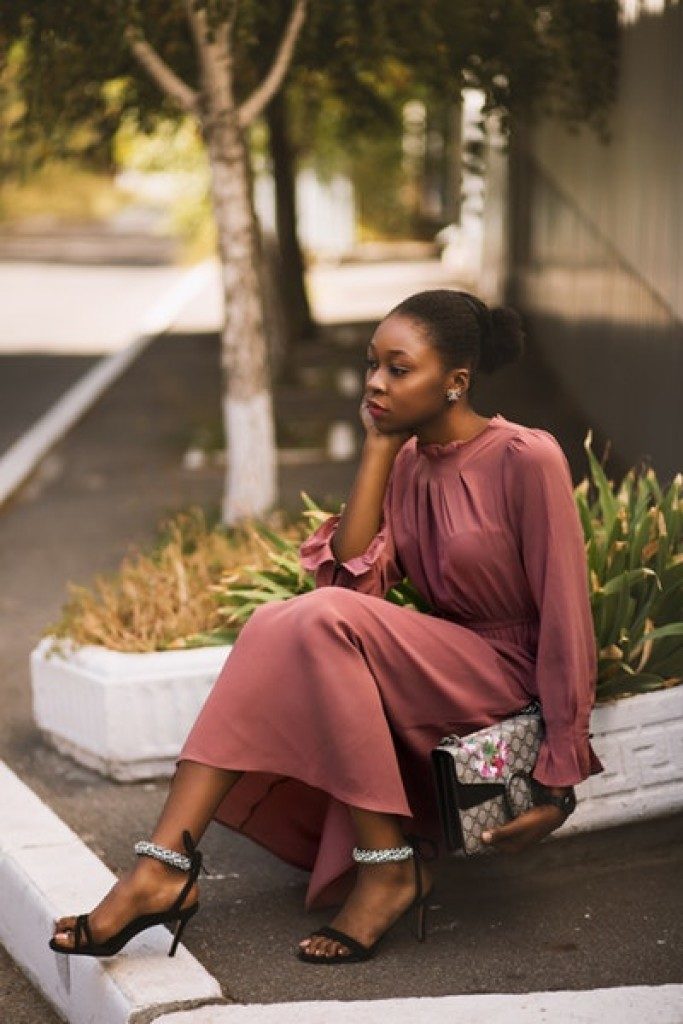 woman sitting on pavement