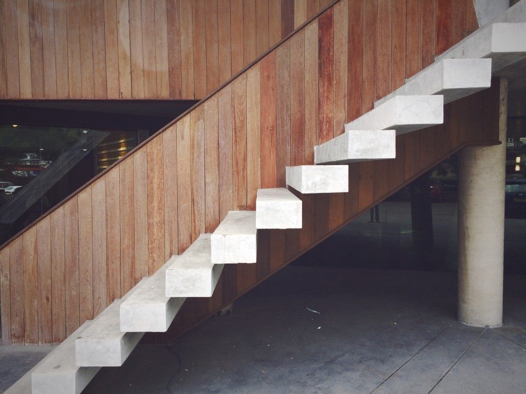 White floating staircase design with the wooden background