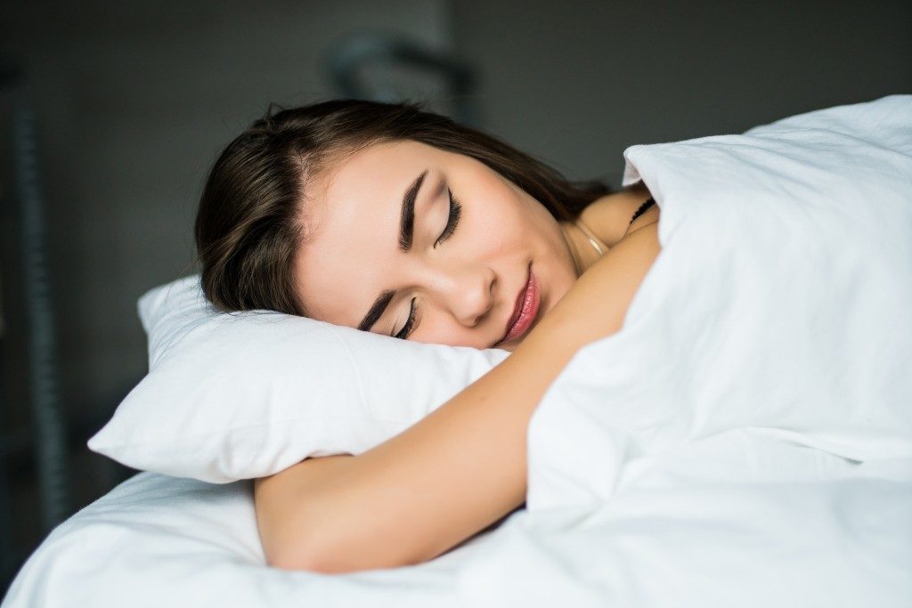 sleeping woman on white linen