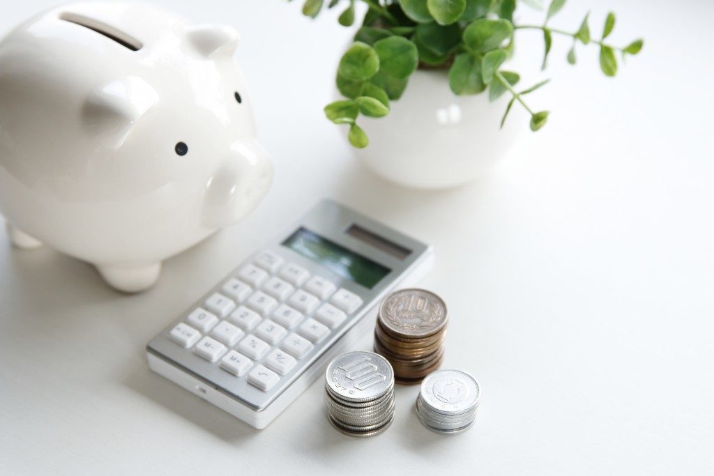 Piggy bank coins and a calculator